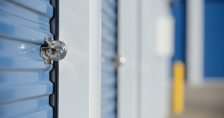 Blue self storage unit doors with a secure lock, representing storage security and pricing