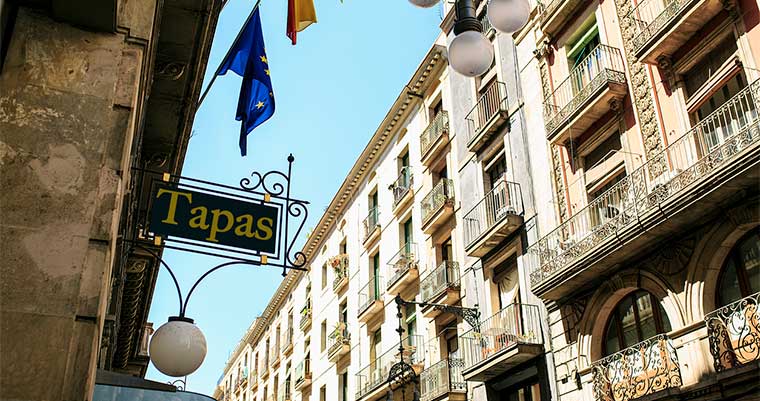 Residential buildings in Madrid under a clear blue sky, capturing the city's atmosphere for student life and food exploration
