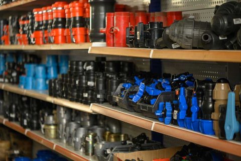 Shelves filled with industrial tools and parts, representing secure equipment storage with OhMyBox.